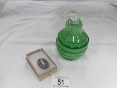 A micro mosaic brooch and a large pear shaped green glass perfume bottle.