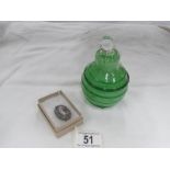 A micro mosaic brooch and a large pear shaped green glass perfume bottle.