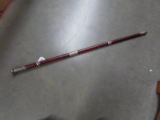 A leather bound walking stick with silver mount.