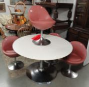 A retro style dining table and 4 chairs.