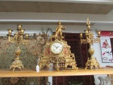 A 3 piece gilt brass clock garniture, the clock surmounted with shepherd boy and dog.