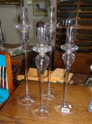 A set of 4 tall contemporary glass candle holders.