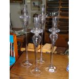 A set of 4 tall contemporary glass candle holders.