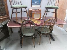 An Ercol dining table and 4 chairs.