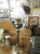 A brass Corinthian column oil lamp complete with shade and chimney.