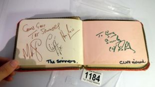 An autograph book with autographs from Sir Cliff Richard, The Spinners, Eartha Kitt, Lewis Collins,