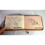 An autograph book with autographs from Sir Cliff Richard, The Spinners, Eartha Kitt, Lewis Collins,