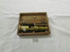 A late 19th century brass field microscope with box (no makers mark).