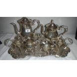 A 4 piece silver plated tea set on tray and a pair of salad servers.