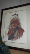 A framed and glazed tapestry of an American Indian chief.