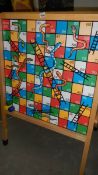 A snakes and ladders easel.