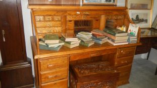 An oak double pedestal roll top desk.