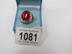 A red jade/silver ring, size P.
