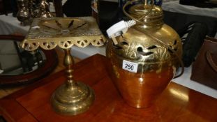 A Victorian brass trivet and a brass lamp base.