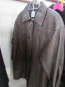 A brown leather coat with embroidered front panels, size 18.