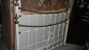 A brass and iron bed surround.