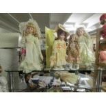 7 porcelain headed collector's dolls.