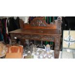 An early carved oak side table.