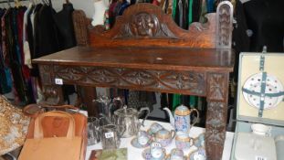 An early carved oak side table.