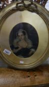 An oval gilt framed and glazed portrait of a lady.