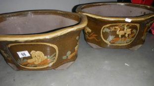 A pair of oriental style garden pots.