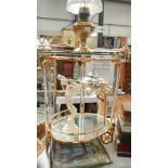 A gilt and glass tea trolley.