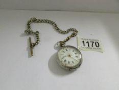 A .935 silver pocket watch in working order, on plated chain.