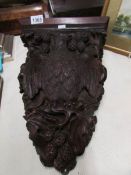 A carved wood eagle wall shelf.