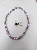 An Honora pearl necklace in lilac/blue colours.