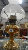A brass oil lamp with shade.