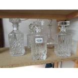 4 square cut glass decanters and one other.