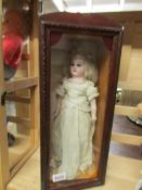 An early German bride doll in cabinet, approximately 16".