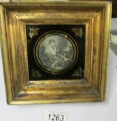 A framed and glazed circular picture of a lady, possibly engraving.
