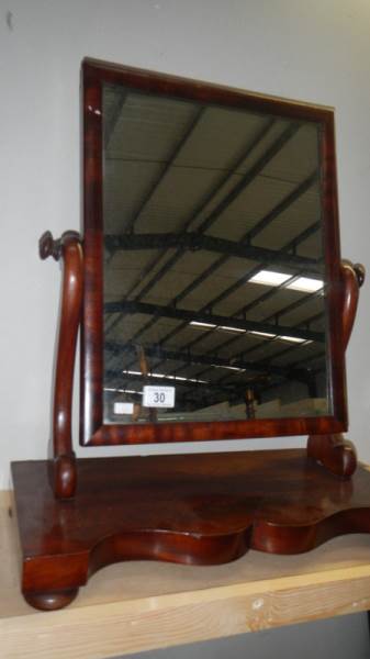 A mahogany toilet mirror.