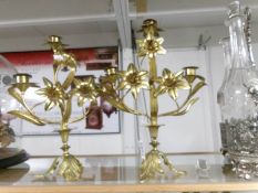 A pair of decorative brass candelabra.