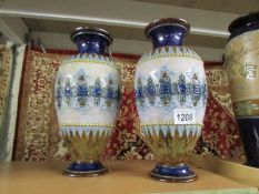 A pair of Royal Doulton floral vases, both bases repaired.
