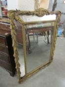 A large decorative mirror, a/f.