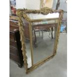 A large decorative mirror, a/f.