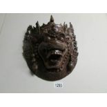 An early 20th century carved hard wood wall mask.