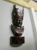 An carved wood wall mask.