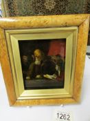 A framed and glazed painting on glass 'The Tax Collector' after Rembrandt.