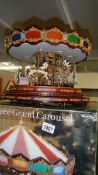 A boxed Mr Christmas Marque Grand Carousel and unboxed big wheel, (no lead).