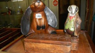 A wooden rabbit, badger and box.