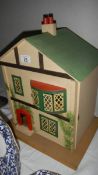 A 1950's dolls house with furniture.