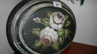 An oval domed front floral painting.