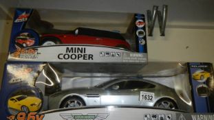 A boxed model Aston Martin and a boxed model Mini Cooper.