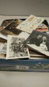 A tin of loose stamps, photographs etc.