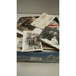 A tin of loose stamps, photographs etc.