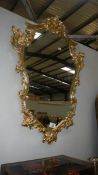 A gilt framed mirror.