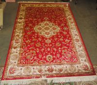 A red ground Keshan carpet (2.3m x 1.